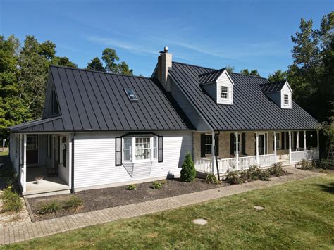 black metal roof white house|house with black metal roof.